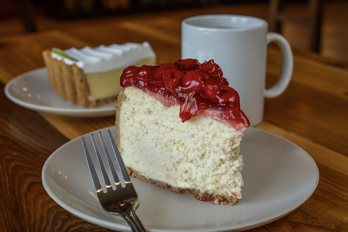 Katzinger's New York Style Cheesecake with cherry topping and slice of Key Lime Pie with coffee.