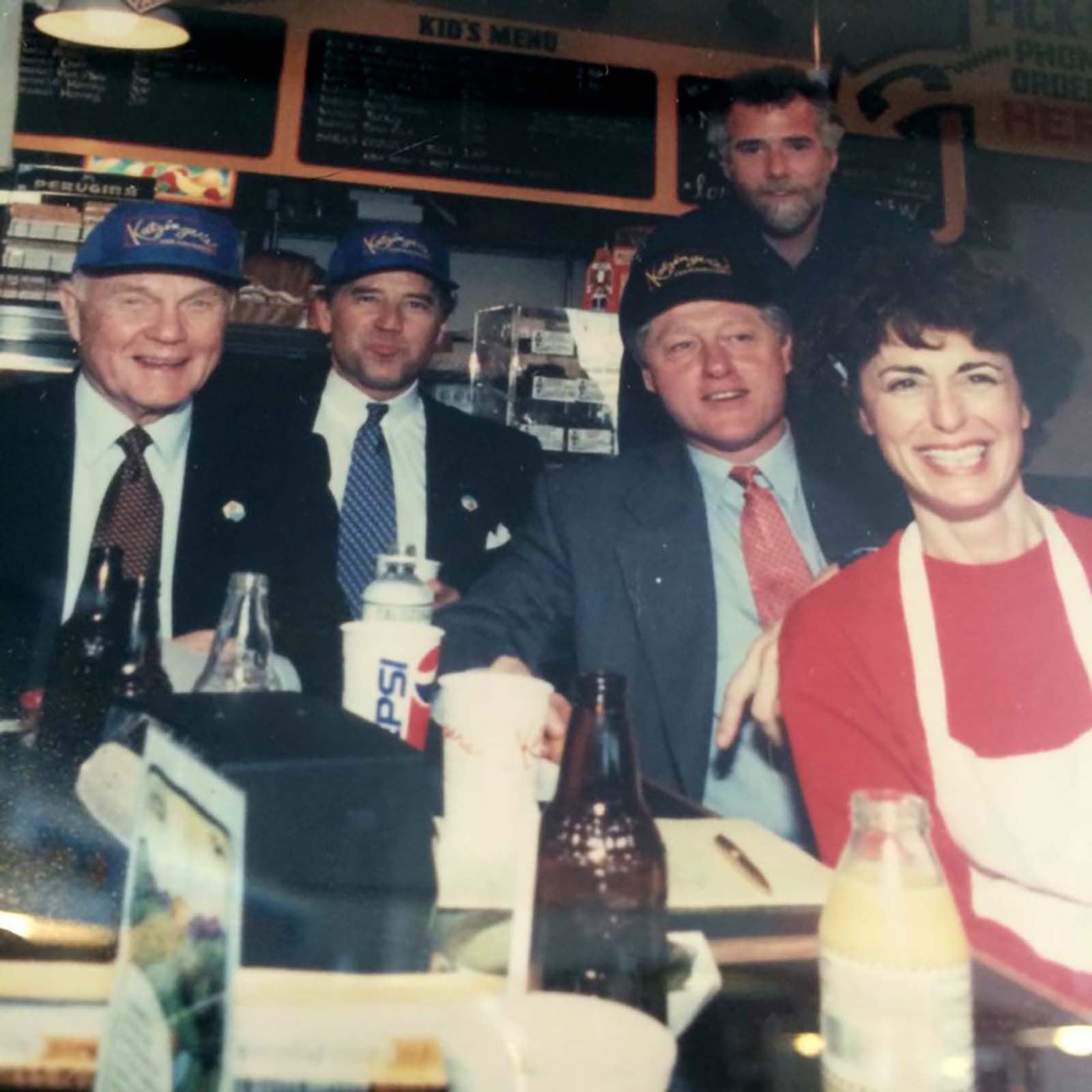 Katzinger's Founder Diane Warren seated with then-President Bill Clinton, Senator John Glenn, Congressman Joe Biden